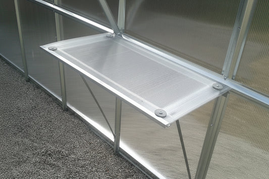 Aluminium greenhouse shelf with triangular bracket support fitted inside
polycarbonate greenhouse — galvanised steel frame staging accessory Ireland