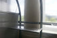 Steel greenhouse shelf suspended by chains from horizontal bar inside arc 
polycarbonate greenhouse — interior staging accessory with chain and tube 
support system Ireland